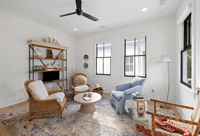 sitting room featuring baseboards, wood finished floors, visible vents, and recessed lighting