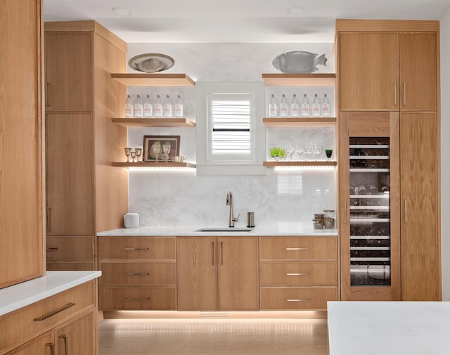 bar featuring wet bar, backsplash, and a sink