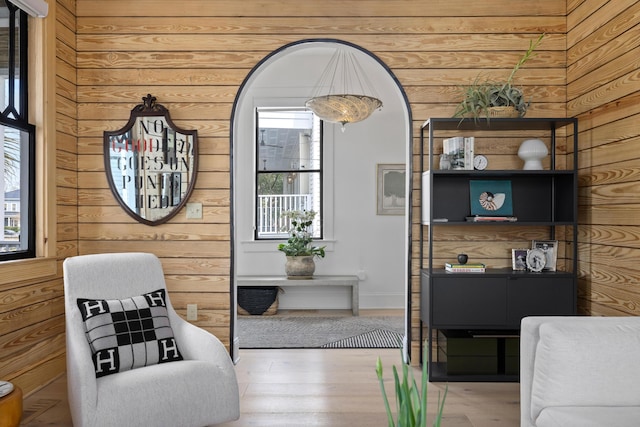 living area featuring wooden walls and wood finished floors