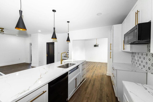 kitchen with dark wood-type flooring, black appliances, a sink, light stone counters, and white cabinets