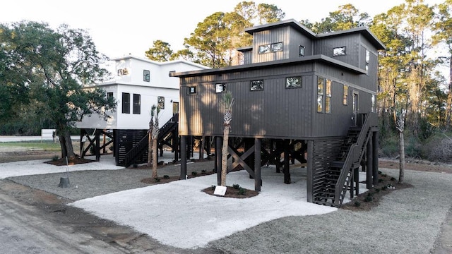 view of front of property featuring a carport and stairway