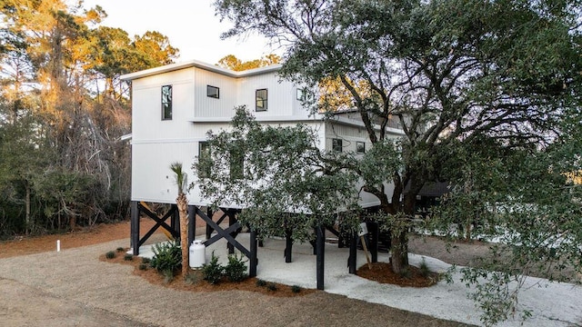 view of front of home featuring stairway and driveway