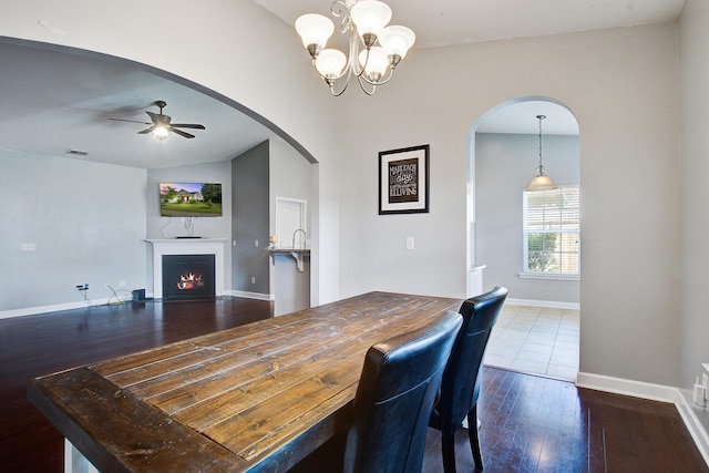 3639 Pimmit Pl, Ladson, SC 29456 - dining space with wood-type flooring, a warm lit fireplace, arched walkways, baseboards, and ceiling fan