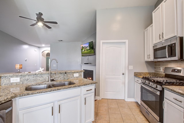 3639 Pimmit Pl, Ladson, SC 29456 - kitchen with stainless steel appliances, a sink, a ceiling fan, arched walkways, and backsplash