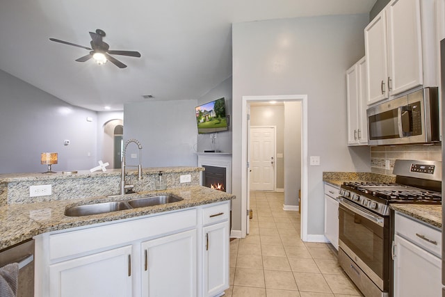 3639 Pimmit Pl, Ladson, SC 29456 - kitchen with appliances with stainless steel finishes, a sink, a ceiling fan, light tile patterned floors, and white cabinetry