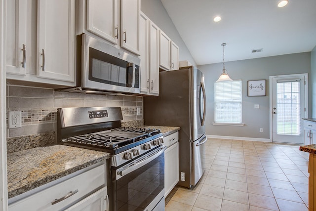 3639 Pimmit Pl, Ladson, SC 29456 - kitchen featuring appliances with stainless steel finishes, baseboards, decorative backsplash, light stone counters, and lofted ceiling