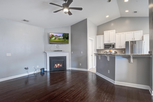 3639 Pimmit Pl, Ladson, SC 29456 - kitchen with appliances with stainless steel finishes, a kitchen breakfast bar, white cabinets, stone counters, and a ceiling fan