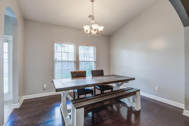 3639 Pimmit Pl, Ladson, SC 29456 - dining area featuring arched walkways, a chandelier, dark wood-type flooring, baseboards, and vaulted ceiling