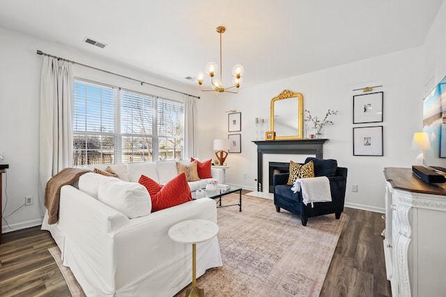 living room featuring an inviting chandelier and dark hardwood / wood-style floors