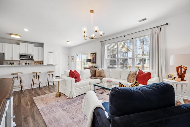 living room featuring dark hardwood / wood-style floors and a chandelier