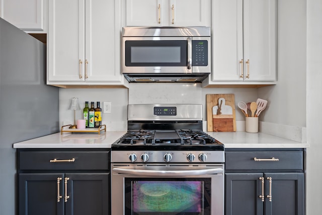 kitchen with white cabinets and appliances with stainless steel finishes