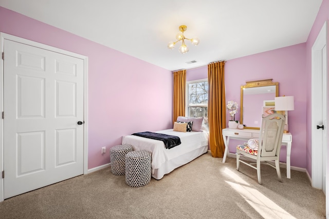 carpeted bedroom featuring a chandelier