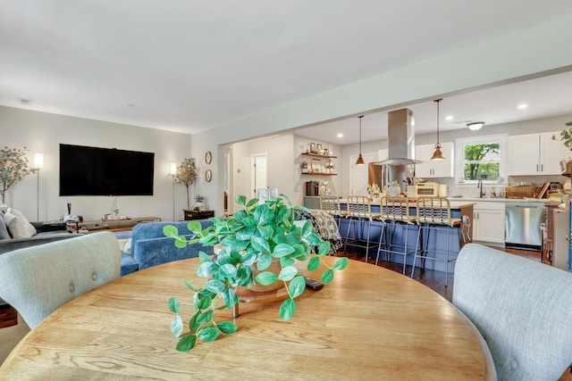 dining space featuring wood finished floors and recessed lighting