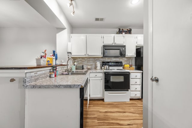 1530 Fort Johnson Rd Unit 1L, Charleston, SC 29412 - kitchen featuring black microwave, electric stove, a sink, and white cabinets