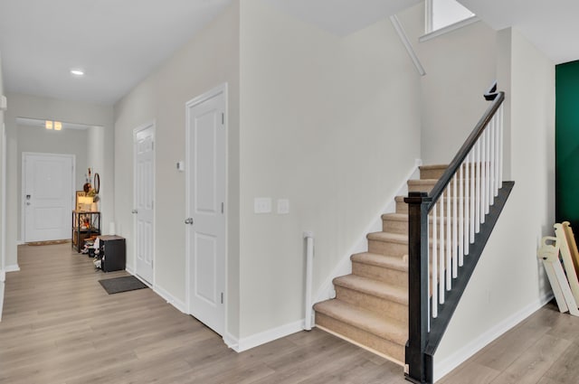 stairs featuring hardwood / wood-style flooring