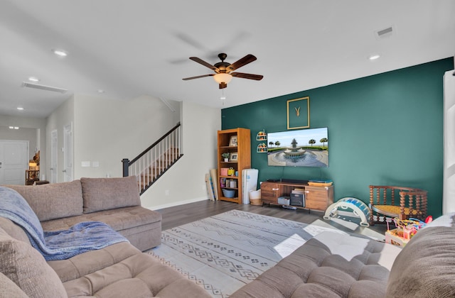 living room featuring ceiling fan and wood-type flooring