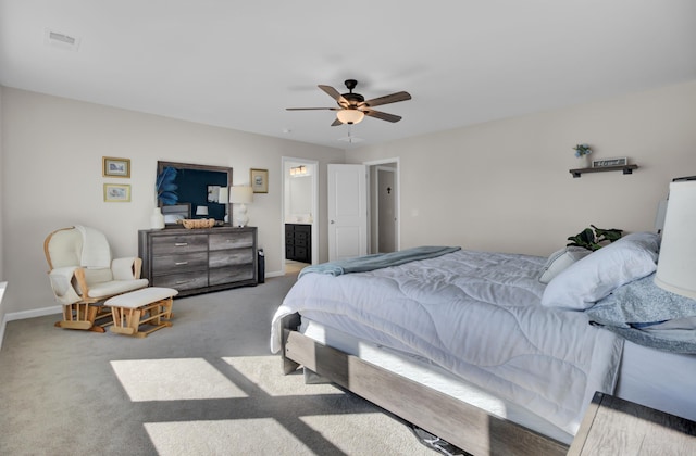 carpeted bedroom featuring ensuite bath and ceiling fan