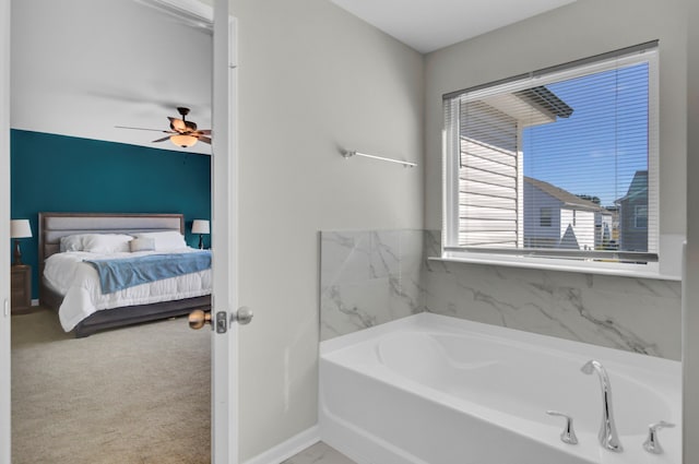 bathroom featuring a bathing tub and ceiling fan