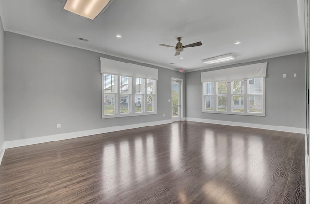 spare room with dark hardwood / wood-style flooring, ceiling fan, and ornamental molding