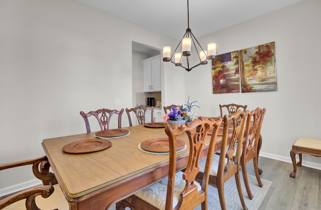 dining space featuring a chandelier and light hardwood / wood-style flooring