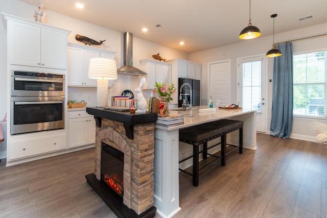 397 Woodgate Way, Summerville, SC 29485 - kitchen with white cabinetry, wall chimney range hood, visible vents, and stainless steel double oven