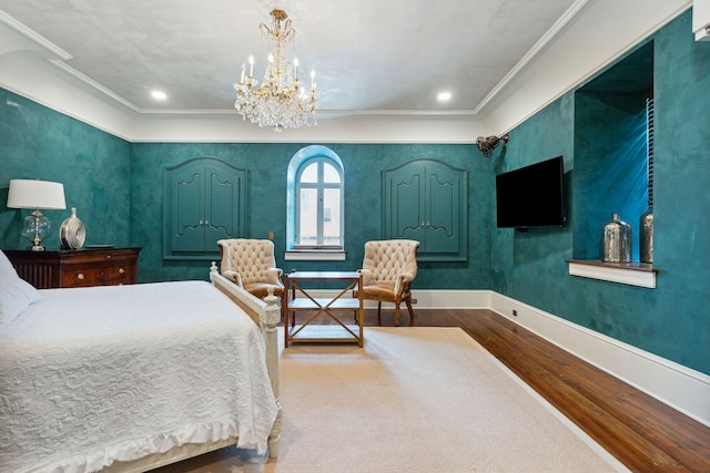 bedroom with crown molding, a notable chandelier, recessed lighting, wood finished floors, and baseboards