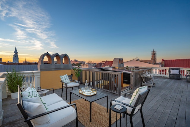 deck at dusk featuring an outdoor living space