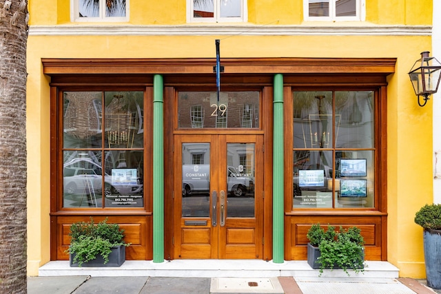 property entrance with stucco siding