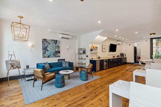 living area featuring an AC wall unit, light wood-style floors, recessed lighting, and wet bar