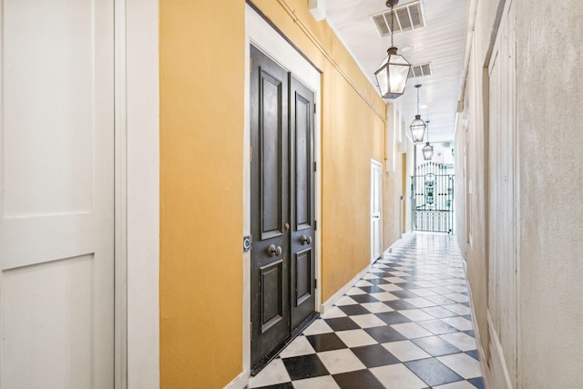 hallway featuring dark floors and visible vents