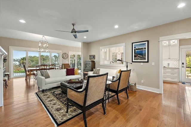 living room with light wood-type flooring, baseboards, and recessed lighting