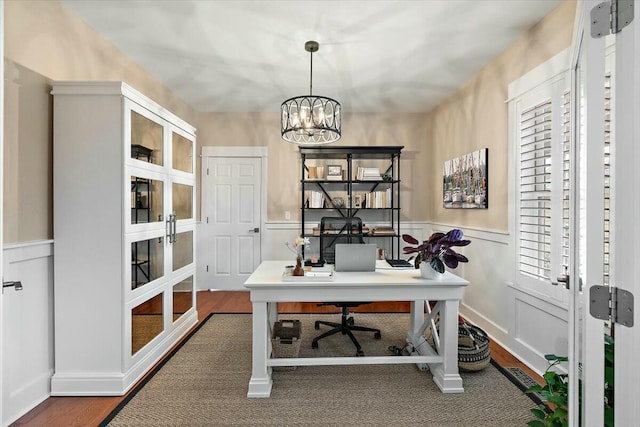 office featuring a chandelier, french doors, dark wood-style flooring, and wainscoting