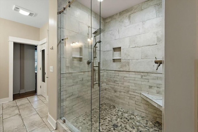 full bath featuring a shower stall, visible vents, and baseboards