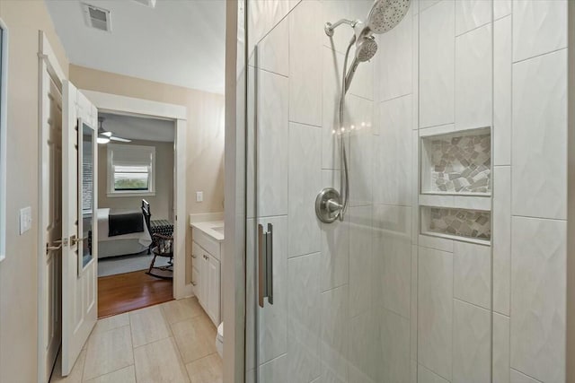 full bathroom featuring tile patterned flooring, visible vents, vanity, a stall shower, and ensuite bath