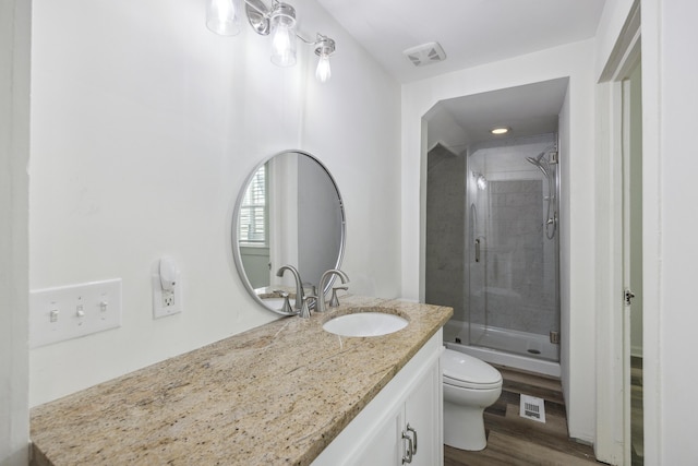 634 Rutledge Ave, Charleston, SC 29403 - full bathroom with toilet, vanity, a stall shower, and wood finished floors