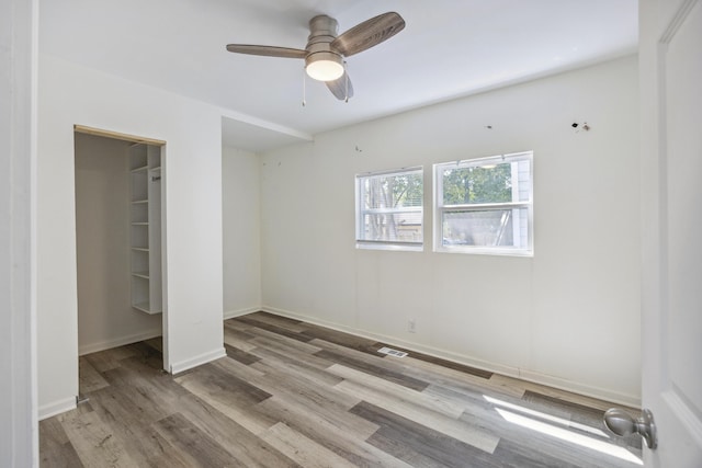 634 Rutledge Ave, Charleston, SC 29403 - unfurnished bedroom featuring wood finished floors, baseboards, and a ceiling fan