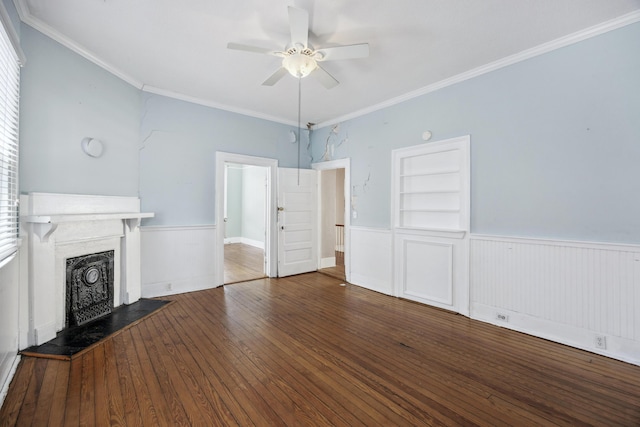 634 Rutledge Ave, Charleston, SC 29403 - unfurnished living room featuring ceiling fan, wainscoting, ornamental molding, hardwood / wood-style flooring, and a fireplace with raised hearth