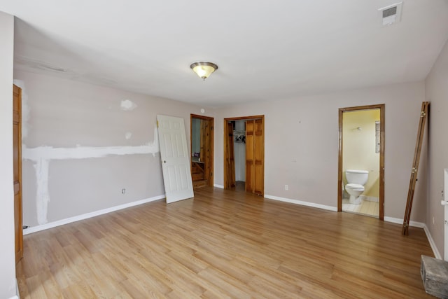 634 Rutledge Ave, Charleston, SC 29403 - unfurnished bedroom with light wood-style flooring, baseboards, a closet, and ensuite bath