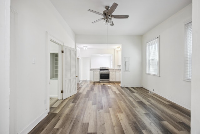 634 Rutledge Ave, Charleston, SC 29403 - unfurnished living room with wood finished floors, a ceiling fan, baseboards, and electric panel