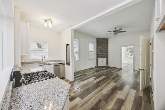 634 Rutledge Ave, Charleston, SC 29403 - kitchen featuring stainless steel dishwasher, a sink, a ceiling fan, white cabinets, and wood finished floors