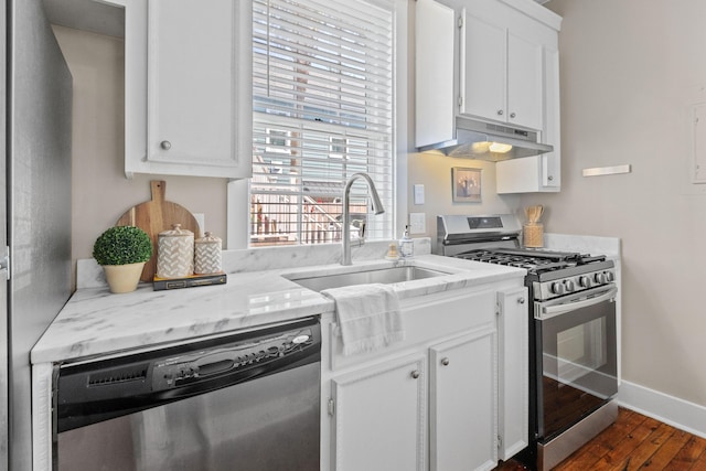 51/2 Kracke St Unit A, Charleston, SC 29403 - kitchen with appliances with stainless steel finishes, under cabinet range hood, dark wood-style floors, white cabinets, and a sink