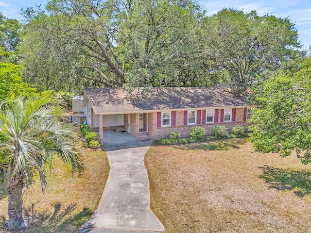 1143 Winborn Dr, Charleston, SC 29412 - single story home featuring roof with shingles, a carport, driveway, and brick siding