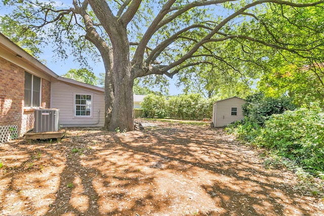 1143 Winborn Dr, Charleston, SC 29412 - view of yard featuring cooling unit, an outdoor structure, and a storage unit