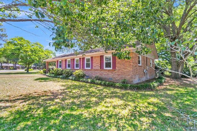1143 Winborn Dr, Charleston, SC 29412 - view of front of house with a front lawn, brick siding, and crawl space