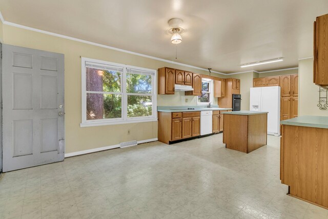 1143 Winborn Dr, Charleston, SC 29412 - kitchen featuring a kitchen island, light countertops, baseboards, under cabinet range hood, and white appliances