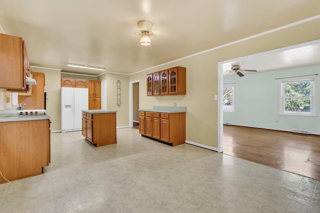 1143 Winborn Dr, Charleston, SC 29412 - kitchen with ceiling fan, a kitchen island, visible vents, brown cabinets, and white fridge with ice dispenser