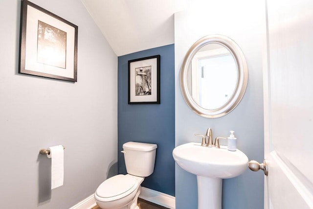 bathroom with vaulted ceiling and toilet