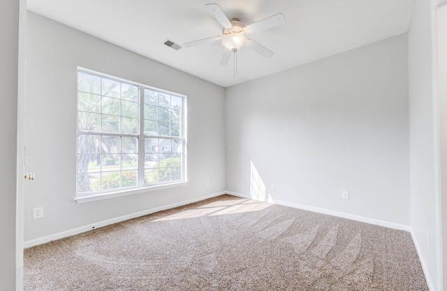 carpeted spare room with ceiling fan