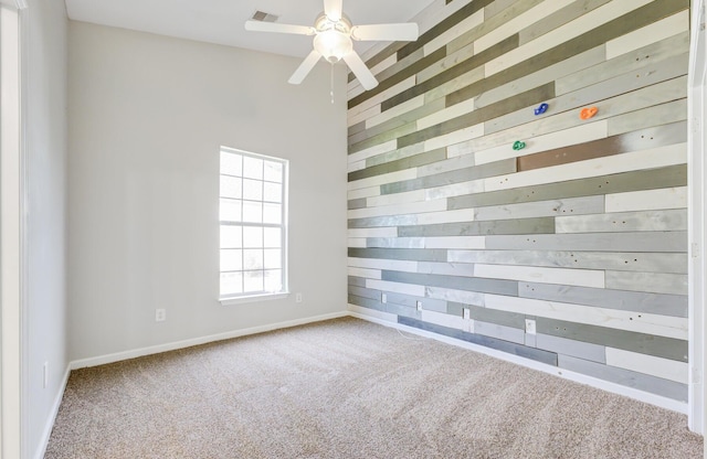 unfurnished room featuring a high ceiling, carpet floors, and ceiling fan