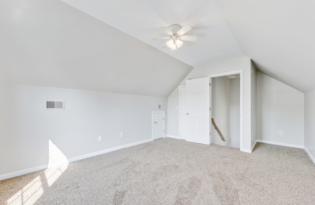 additional living space featuring lofted ceiling, light colored carpet, and ceiling fan